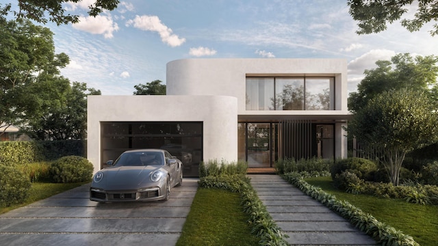 view of front of house with a garage, concrete driveway, and stucco siding