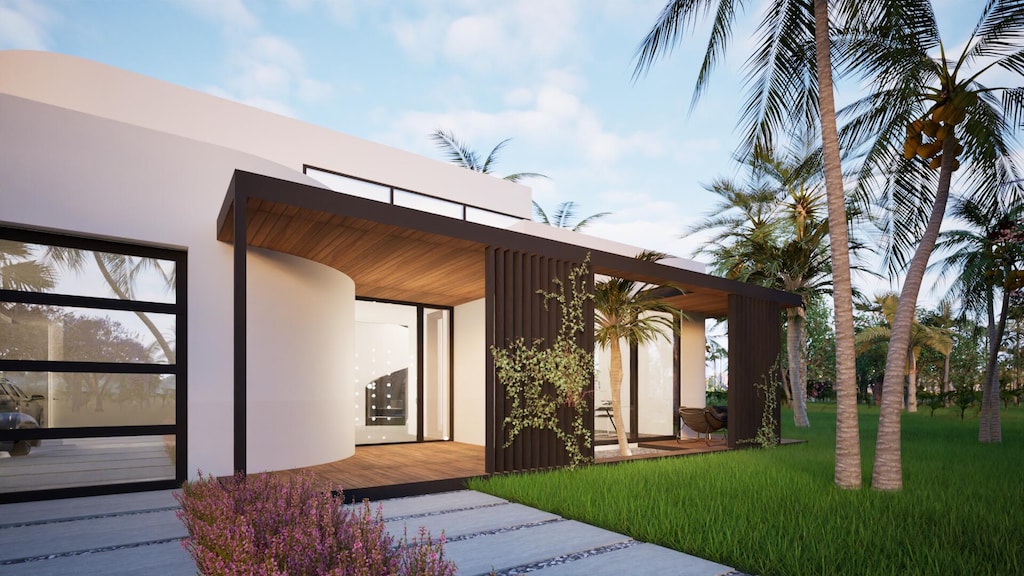 entrance to property featuring a lawn and stucco siding