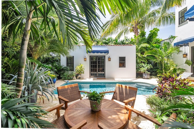 3017 Vincent Rd, West Palm Beach, FL 33405 - outdoor pool with a patio area and french doors