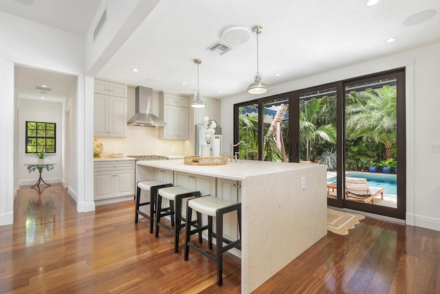 3017 Vincent Rd, West Palm Beach, FL 33405 - kitchen with wall chimney range hood, plenty of natural light, dark wood-style flooring, and recessed lighting