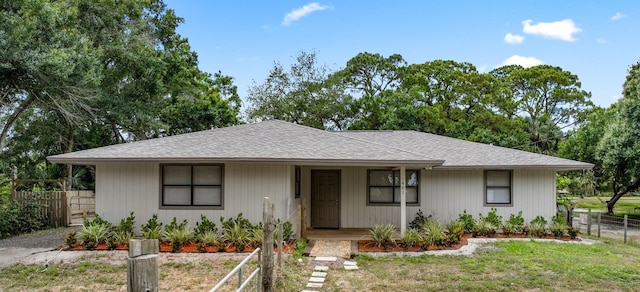 bungalow-style home featuring a shingled roof and covered porch