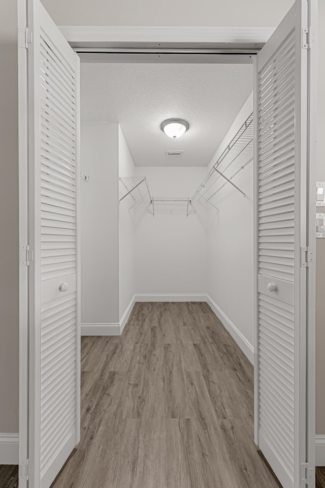 walk in closet featuring light wood-type flooring