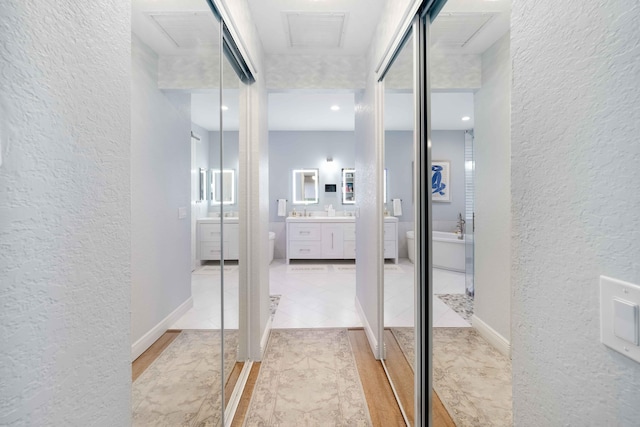 hallway featuring a textured wall