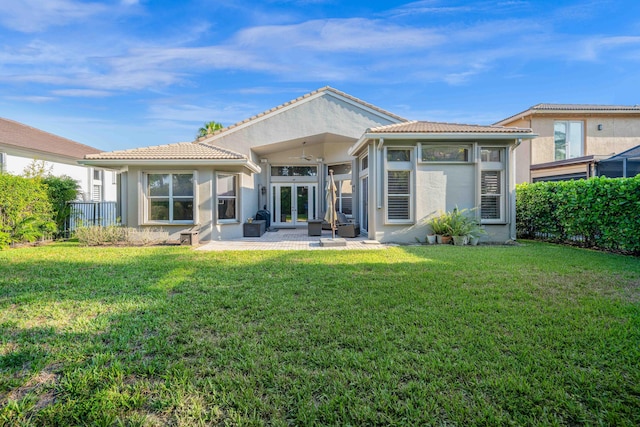 back of property featuring french doors, stucco siding, a tiled roof, and a patio