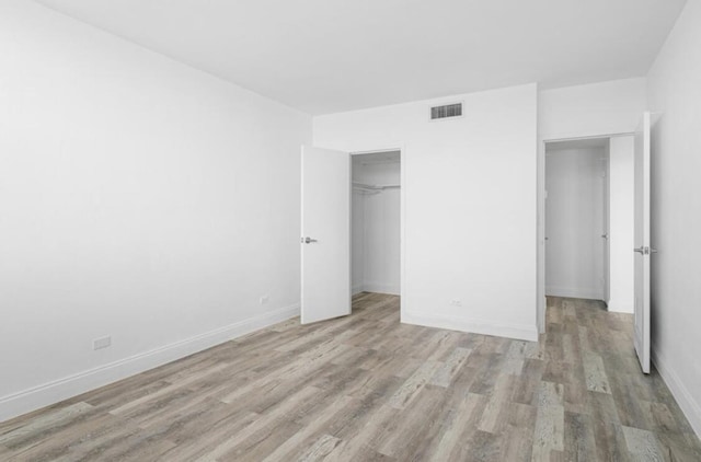 2800 N Flagler Dr Unit 410, West Palm Beach, FL 33407 - unfurnished bedroom featuring baseboards, a closet, visible vents, and wood finished floors