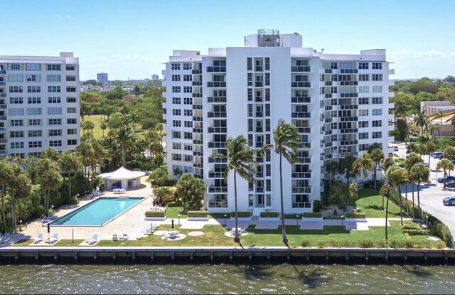2800 N Flagler Dr Unit 410, West Palm Beach, FL 33407 - view of building exterior with a water view and a community pool