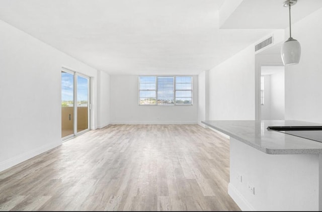 2800 N Flagler Dr Unit 410, West Palm Beach, FL 33407 - unfurnished living room featuring baseboards, light wood-style floors, and visible vents
