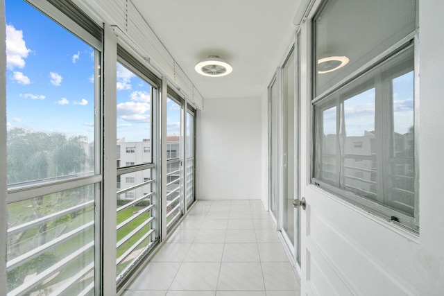 unfurnished sunroom featuring tile patterned flooring