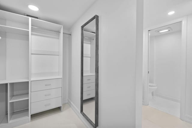 spacious closet with light tile patterned floors