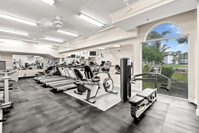 workout area with a textured ceiling and baseboards