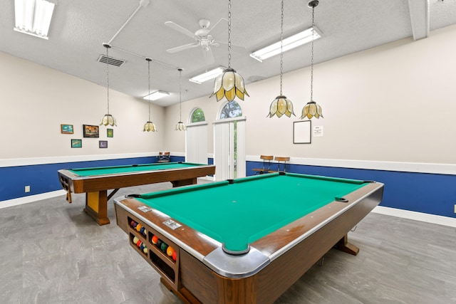 game room featuring a textured ceiling, pool table, ceiling fan, and baseboards