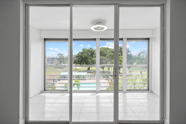 doorway to outside featuring tile patterned flooring and healthy amount of natural light