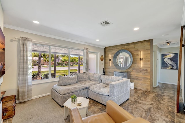 living room with crown molding, wood walls, baseboards, and visible vents