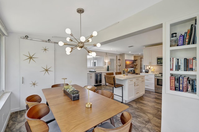 dining room featuring wine cooler, a notable chandelier, recessed lighting, and stone finish floor