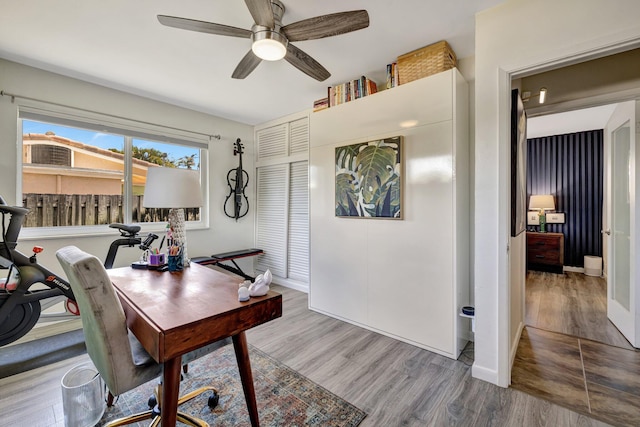 home office featuring baseboards, wood finished floors, and a ceiling fan