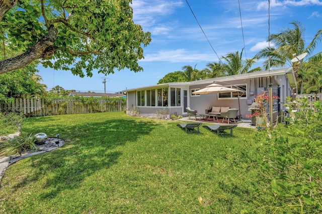 view of yard with an outdoor living space, a patio area, and a fenced backyard