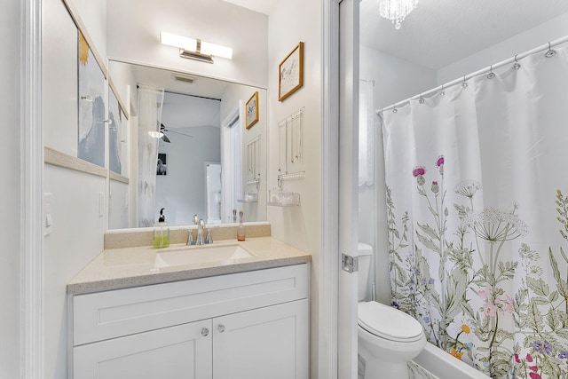 bathroom featuring a ceiling fan, toilet, vanity, and curtained shower