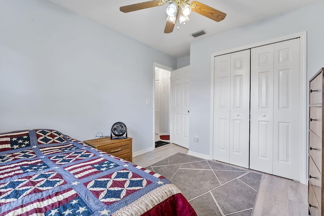 tiled bedroom featuring a closet and ceiling fan