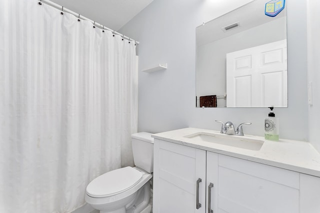 full bathroom featuring toilet, vanity, and curtained shower