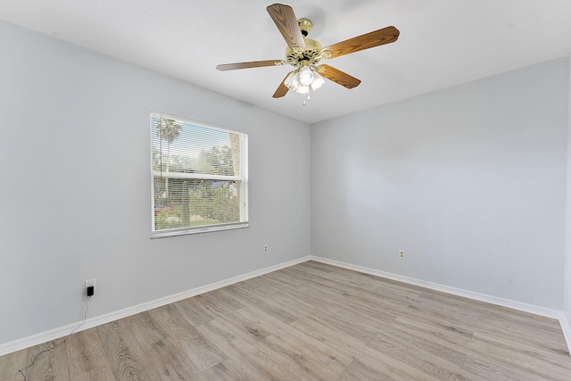 spare room featuring light wood-style floors, baseboards, and ceiling fan