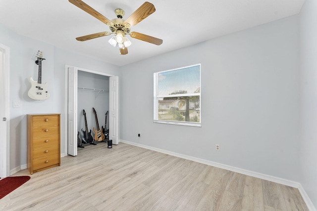 unfurnished bedroom featuring light wood finished floors, a closet, and baseboards