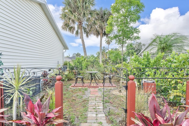 view of yard with fence and a gate