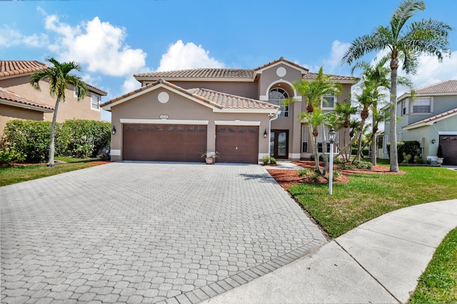 12774 Spikerush Cir, Boca Raton, FL 33428 - mediterranean / spanish-style house with a front lawn, stucco siding, decorative driveway, and an attached garage