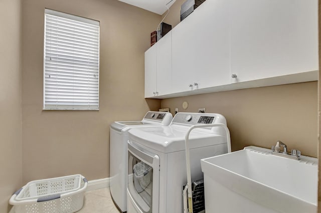 12774 Spikerush Cir, Boca Raton, FL 33428 - laundry area featuring light tile patterned floors, a sink, cabinet space, separate washer and dryer, and baseboards