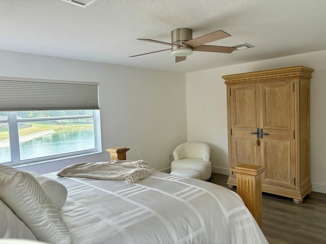 12774 Spikerush Cir, Boca Raton, FL 33428 - bedroom featuring a textured ceiling, visible vents, wood finished floors, and a ceiling fan