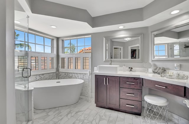12774 Spikerush Cir, Boca Raton, FL 33428 - full bath featuring recessed lighting, marble finish floor, a sink, a freestanding tub, and double vanity