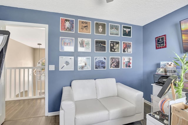 12774 Spikerush Cir, Boca Raton, FL 33428 - sitting room featuring a textured ceiling, wood finished floors, and baseboards