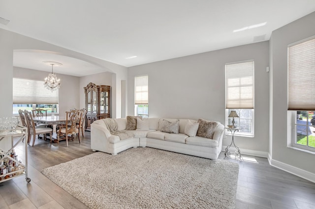 12774 Spikerush Cir, Boca Raton, FL 33428 - living room featuring wood finished floors, baseboards, arched walkways, and a notable chandelier