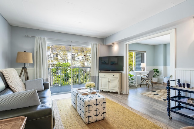 855 Dahlia Ln Unit 306, Vero Beach, FL 32963 - living area featuring wainscoting, plenty of natural light, and wood finished floors
