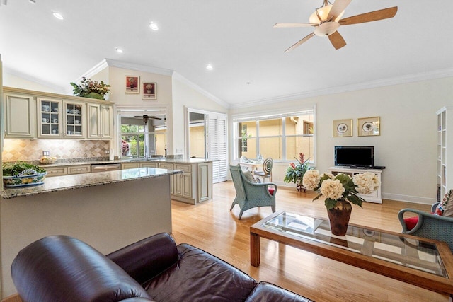 living area with lofted ceiling, recessed lighting, ceiling fan, crown molding, and light wood-style floors