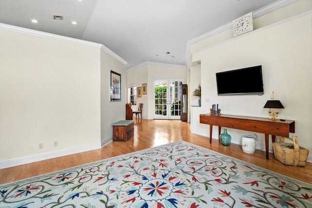 living room with french doors, wood finished floors, baseboards, ornamental molding, and recessed lighting