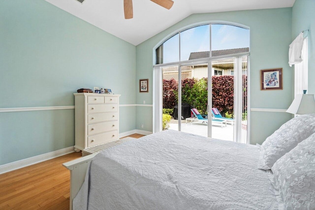 bedroom featuring a ceiling fan, baseboards, vaulted ceiling, wood finished floors, and access to exterior