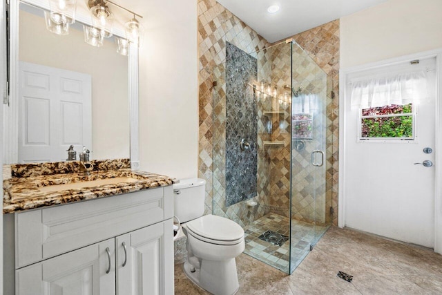 full bathroom with vanity, toilet, and a stall shower