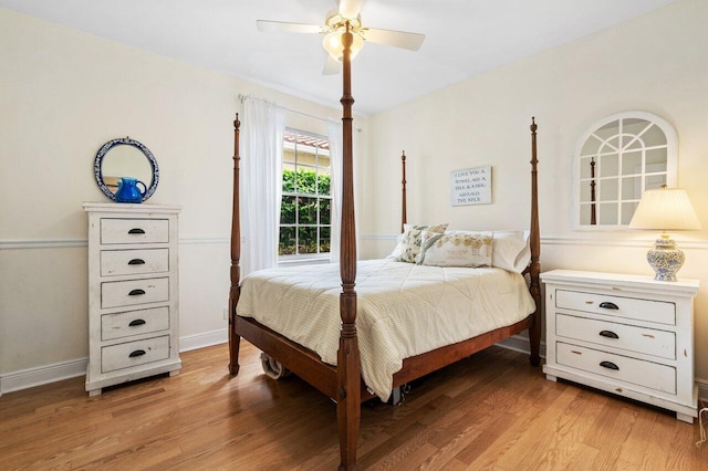 bedroom featuring a ceiling fan, light wood-style floors, and baseboards