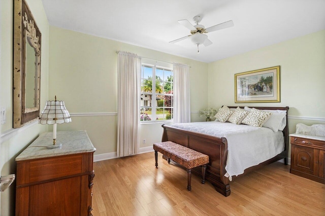 bedroom featuring light wood finished floors, baseboards, and ceiling fan
