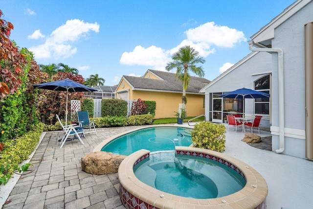 view of pool featuring a patio area and a pool with connected hot tub