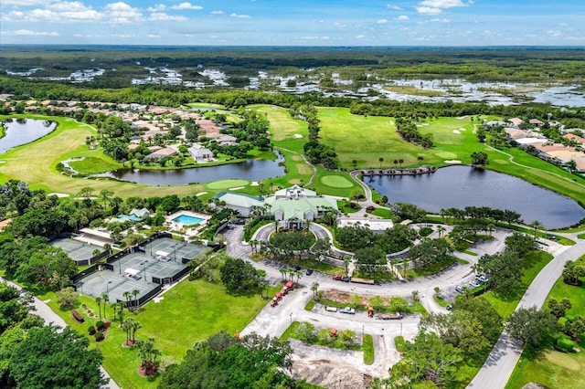 drone / aerial view featuring a water view, golf course view, and a residential view