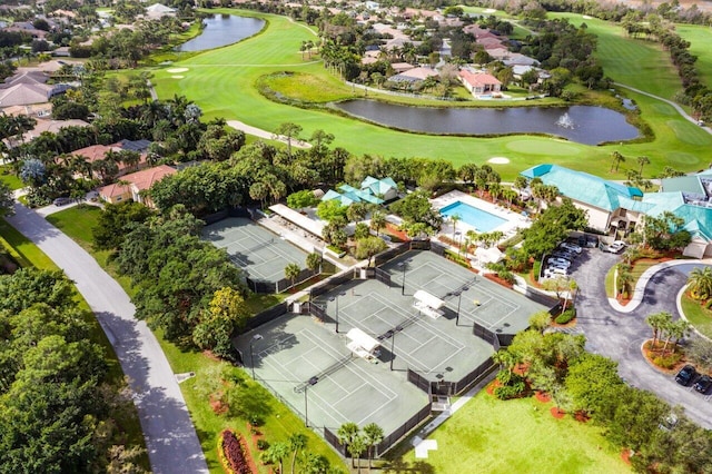 drone / aerial view featuring a water view, a residential view, and view of golf course