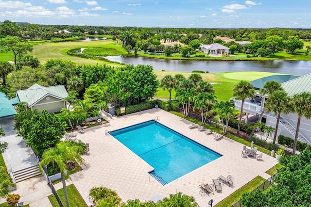 pool featuring fence, a water view, a patio, and golf course view