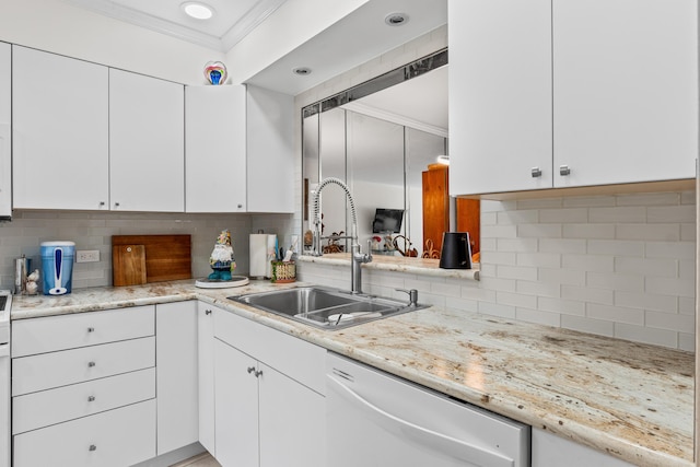 kitchen featuring a sink, backsplash, white cabinets, and dishwasher