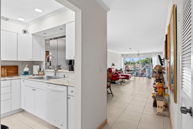 kitchen featuring white dishwasher, light tile patterned flooring, a sink, crown molding, and tasteful backsplash