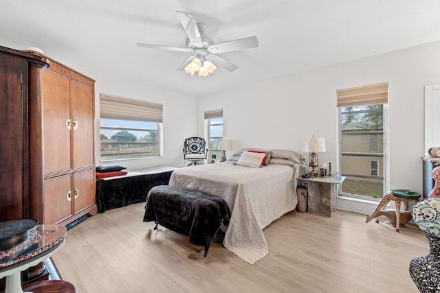 bedroom featuring light wood-type flooring and a ceiling fan