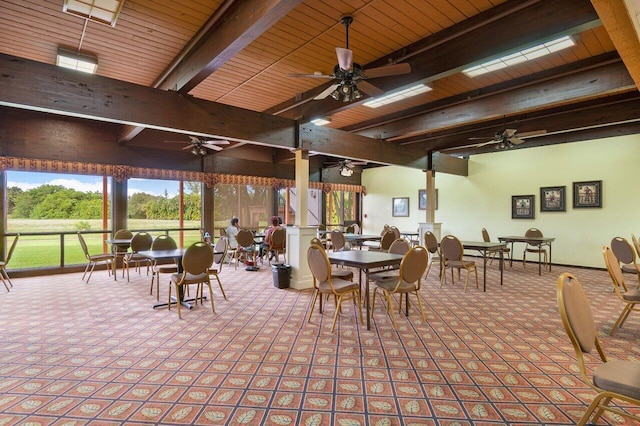 carpeted dining room featuring wood ceiling, plenty of natural light, and beam ceiling
