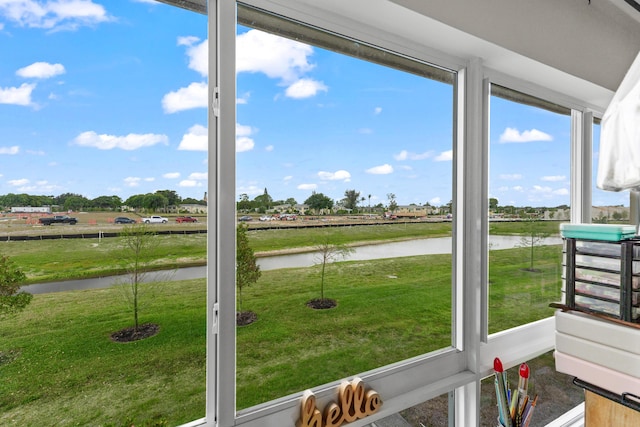 unfurnished sunroom with a water view