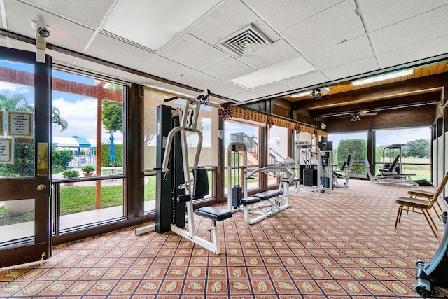 gym with a ceiling fan, a healthy amount of sunlight, and visible vents
