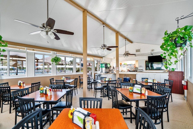 dining space featuring a ceiling fan and lofted ceiling with beams